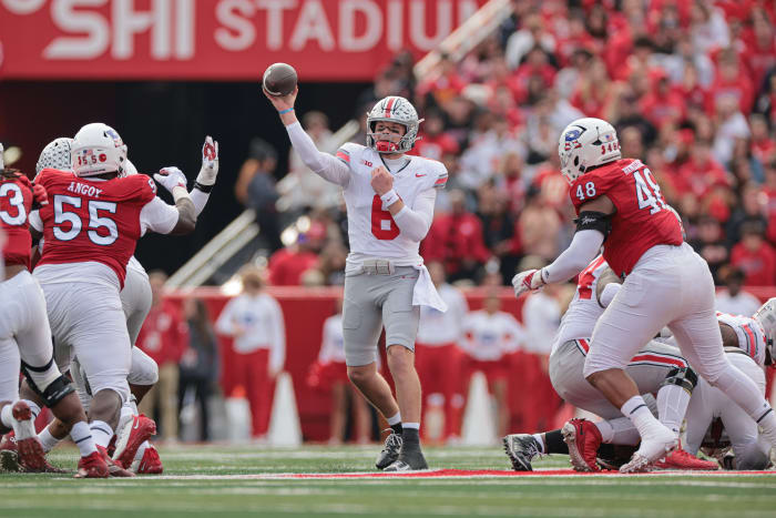 Nov 4, 2023; Piscataway, New Jersey, USA; Ohio State Buckeyes quarterback Kyle McCord (6) throws the ball against Rutgers Scarlet Knights defensive lineman Zaire Angoy (55) and defensive lineman Kyonte Hamilton (48) during the first half at SHI Stadium.